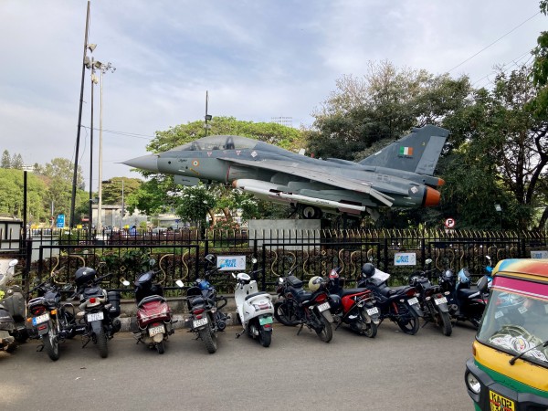 A fighter-style plane is displayed prominently on the street like a statue would be